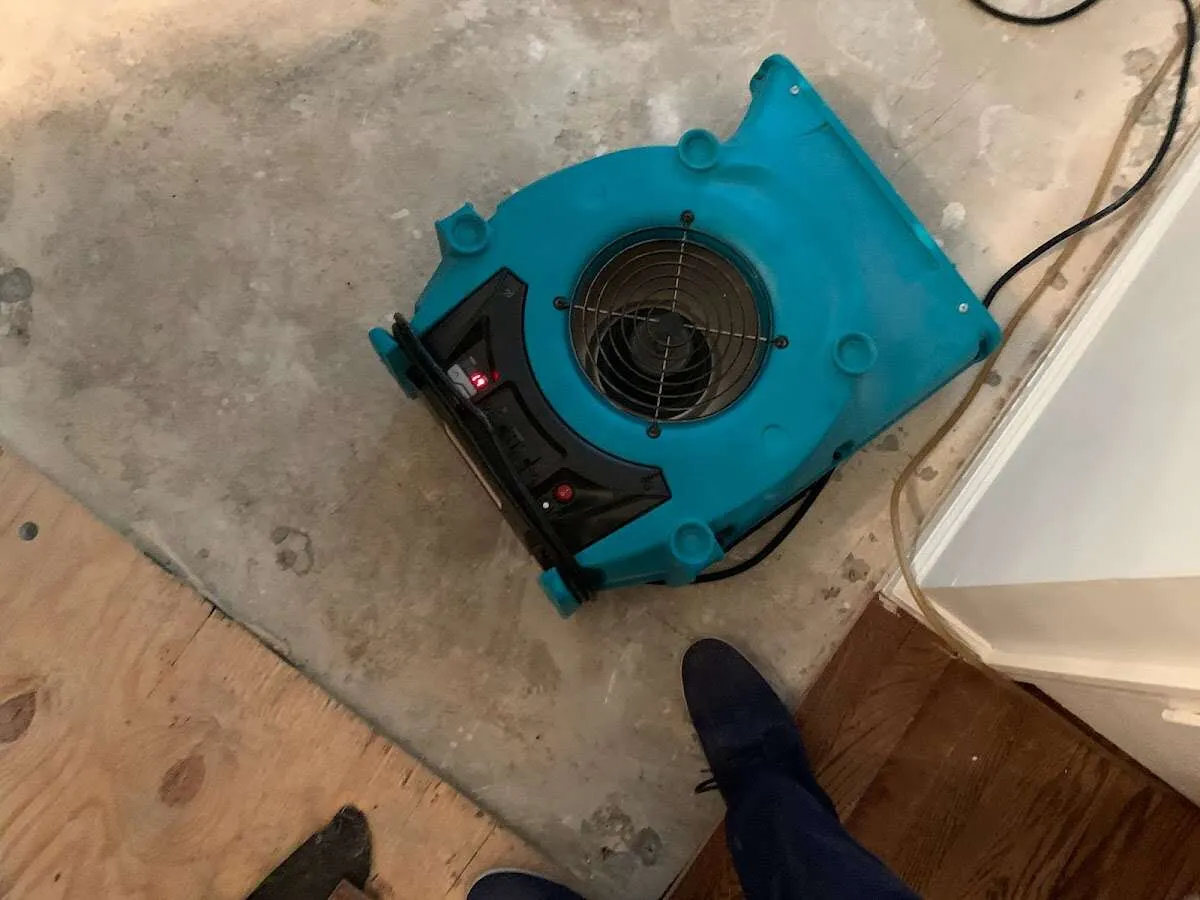 Air mover drying subfloor during Commercial Water Damage Restoration in Wauconda